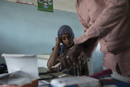 A doctor prepares a malaria test for a 23-year-old Tigray refugee in Hamdaet, eastern Sudan
