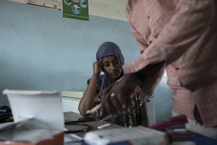 A doctor prepares a malaria test for 23-year-old Tigrayan refugee in Hamdayet, eastern Sudan