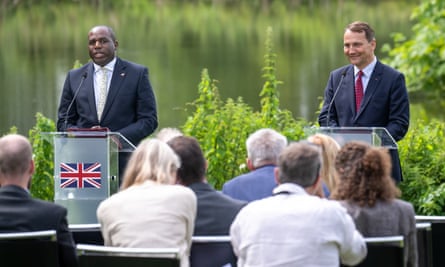David Lammy and Radoslaw Sikorski standing behind lecterns