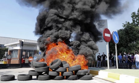 Tyres are burned during a protest in front of the Nissan factory in Barcelona, which is going to close.