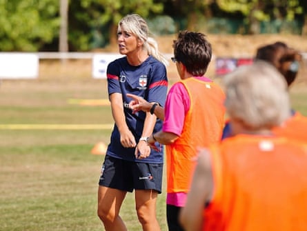 Gemma Darvill, the head coach of the England women’s Parkinson’s team, speaks to her players during a training session