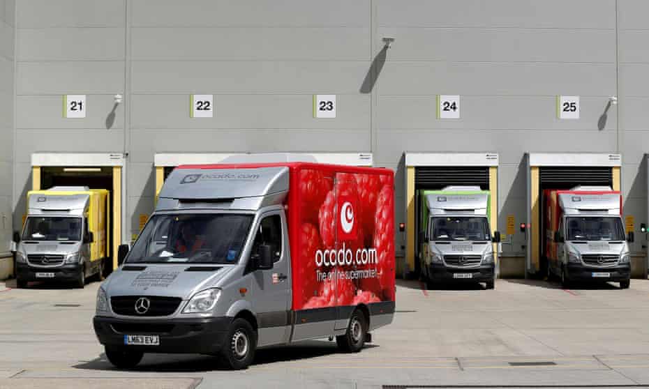 A delivery van leaves the dispatch area of the Ocado customer fulfilment centre in Andover.
