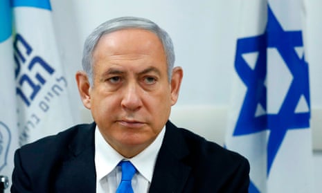Benjamin Netanyahu in front of an Israeli flag