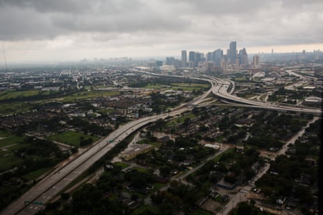 A massive city under a cloudy, stormy sky.