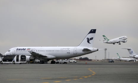 A Iranian Mahan Air passenger plane takes off as a plane of Iran’s national air carrier, Iran Air, is parked at left, at Mehrabad airport in Tehran, Iran.
