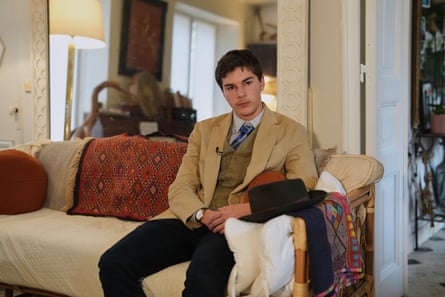 Pedro Elias Garzon Delvaux sits on a couch