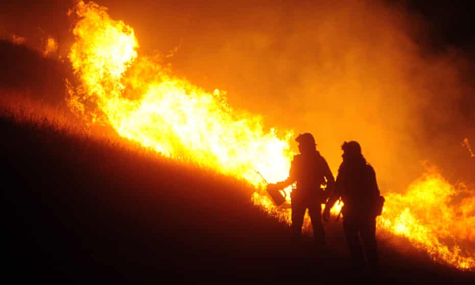 Fire crews work to contain the Qual fire near Winters, California, on 6 June. 