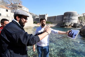 A guide shows a picture of a Game of Thrones scene to fans by the Lovrijenac fort
