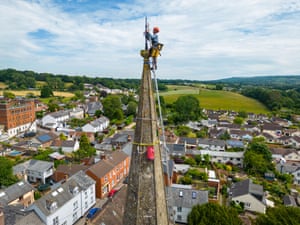 Uffculme, UKArthur Needham paints the lightning conductor on the steeple as part of restoration work on St Mary’s church