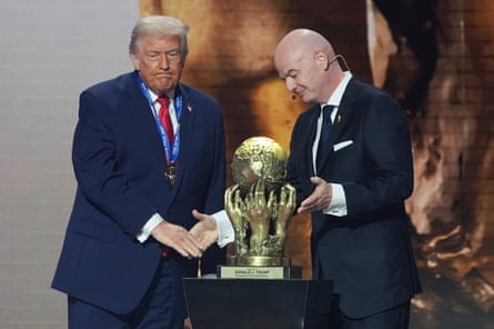 FIFA President Gianni Infantino presents President Donald Trump with the FIFA Peace Prize during the draw for the 2026 soccer World Cup at the Kennedy Center in Washington, Friday, Dec. 5, 2025.