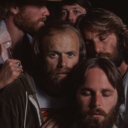 The Beach Boys huddled together.