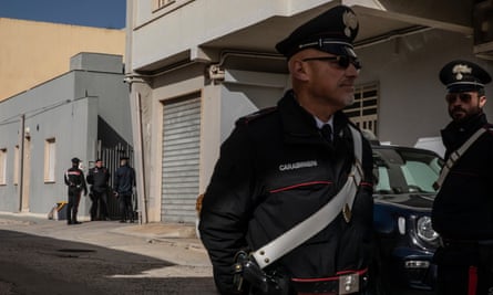 Carabinieri police stand guard near Denaro’s apartment.
