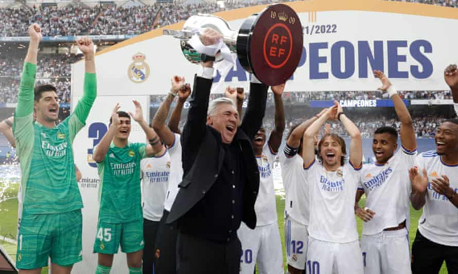 Carlo Ancelotti holds the La Liga trophy aloft – Real Madrid’s 35th league title.