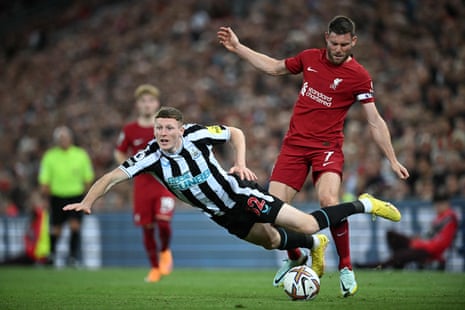 Newcastle United's Elliot Anderson goes flying after a challenge by Liverpool's James Milner.