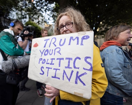 Protesters gather outside Windsor Castle earlier on Tuesday ahead of the arrival of Donald Trump.