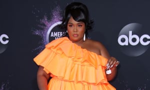 Small holdings: the tiny handbags that became a big thing | Fashion Lizzo at the American Music Awards, in an orange off-the shoulder ruffle, layered dress and holding a tiny Valentino bag between her fingers.