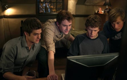 Four young boys sitting around a computer