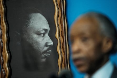 A Martin Luther King Jr picture is seen as Rev Al Sharpton speaks during commemoration of MLK Day at the National Action Network in New York City, on Monday.