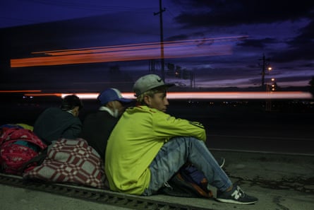 Venezuelans on their way to get back to their country wait by the roadside in Bogotá, Colombia.