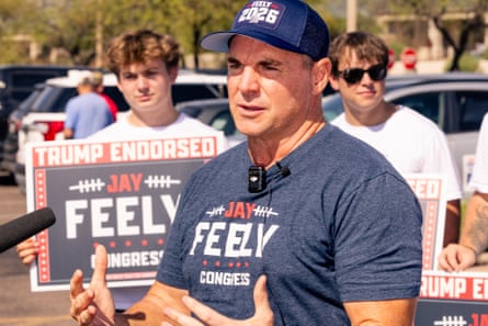 Jay Feely, Congressional candidate, gestures while speaking, with supporters holding campaign signs behind him