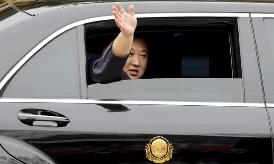 Kim Jong-un waves from a car after arriving by train in Dong Dang