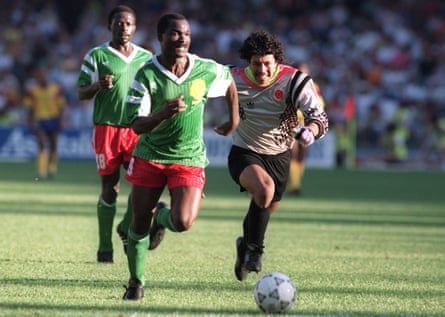 Roger Milla races away from the Colombia goalkeeper, René Higuita, to score for Cameroon.