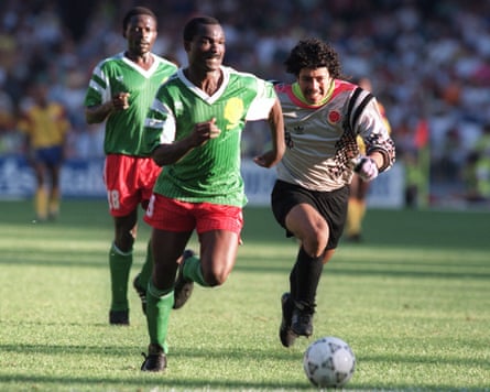 Roger Milla from Cameroon runs past René Higuita to score