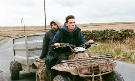 Actors Alec Secareanu and Josh O’Connor on a tractor in a scene from the film God’s Own Country