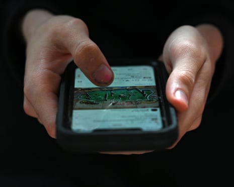 A young person accesses social media on a smartphone