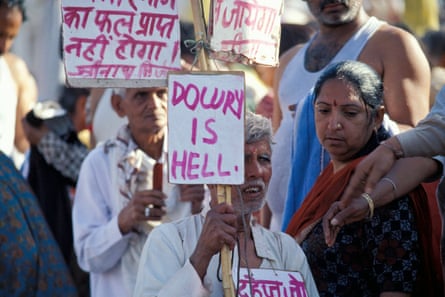 Indians protesting, with signs in a South Asian language and English, with slogans such as ‘dowry is hell’