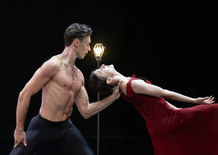 Joseph Taylor and Alina Cojocaru dance in Ghost Light, as she leans backward beside a glowing lamp
