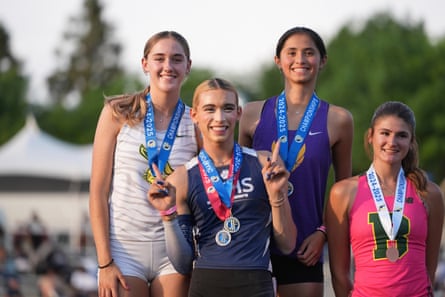 Four girls wearing medals and smiling