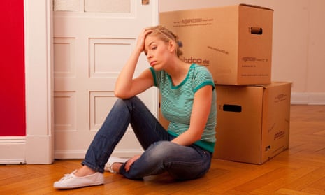 Young woman sitting in front of moving boxes