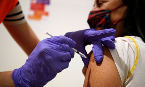 A medical worker administers a dose of the Pfizer-BioNTech vaccine in Paris.