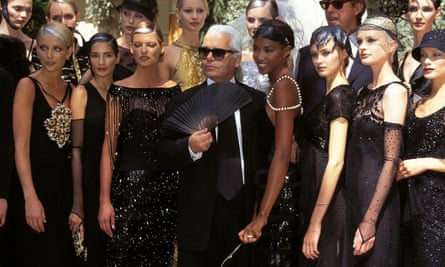Karl Lagerfeld with models, and fan, after a Chanel show in 1996