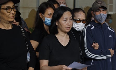 Pansy Ho, centre, announces the death of her father outside a hospital in Hong Kong