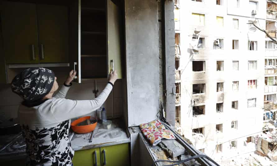 A woman shows damage at her house in Chernihiv Oblast, Ukraine.
