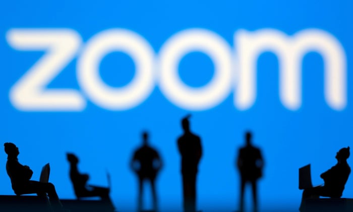Small toy figures are seen in front of Zoom logo in this illustration picture.
