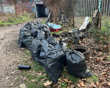 Black bags of rubbish removed by volunteers during the cleanup of the River Roding