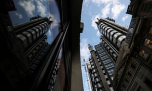 The Lloyd’s of London building is reflected in a window in the City of London financial district.