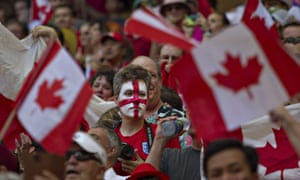 England supporter is surrounded by Canadian flags.