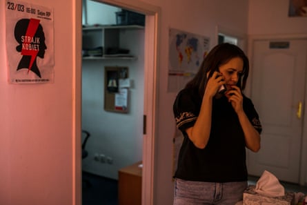 Kamila Ferenc, a lawyer, talks on the phone in a room 