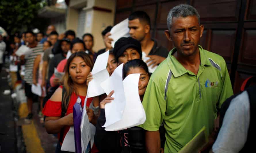 Cuban migrants wait outside the Mexican Commission for Refugee Assistance in Tapachula, Mexico.