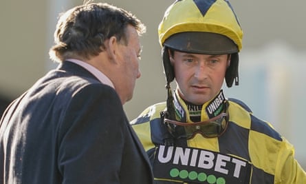 Nico de Boinville talks with trainer Nicky Henderson after Shishkin refused to race at Ascot.