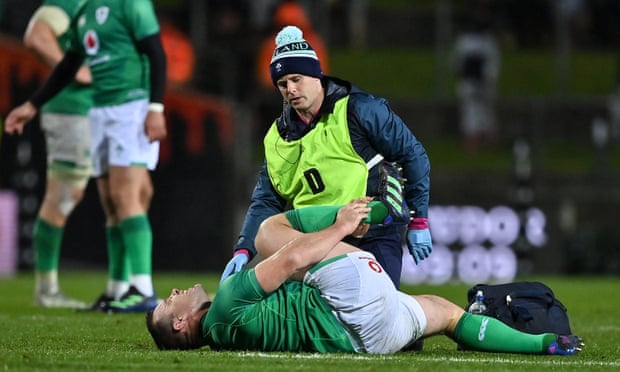 Cian Healy receives medical attention for an ankle injury during the match.