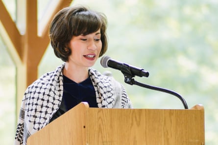 woman speaks into mic at podium