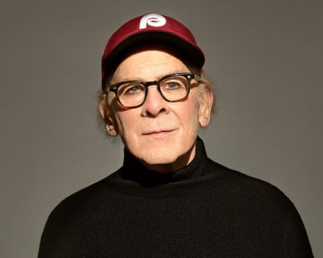 Portrait of Art Garfunkel in black jumper and baseball cap
