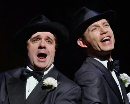 Two men singing on stage