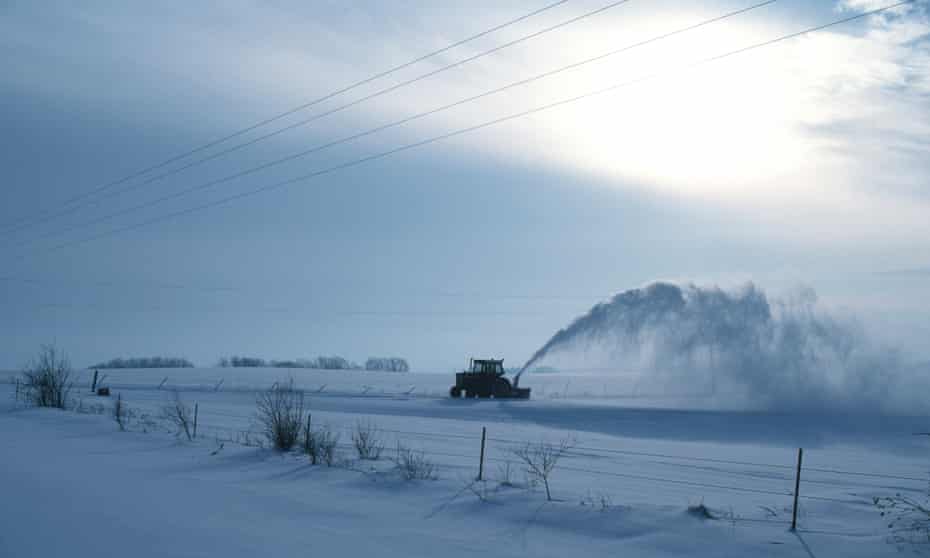 Snow in Midwest<br>Farmer clearing snow from driveway in rural Iowa