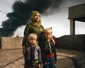 Rana, 38, with her sons, Ali and Mohammed, on the roof of their house in Qayyarah, northern Iraq